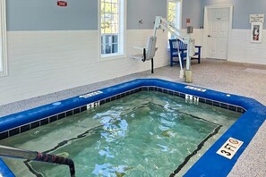 A small indoor pool with a 3 FT depth marker, a ladder, and a sign indicating a 3 FT depth. - Calabash Golf Condo | 15 Min to Beach (Calabash)