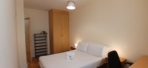 A bedroom with a bed, a wardrobe, a nightstand, and a desk. - Modern 3BDR Home Heart of The Liberties (Dublin)