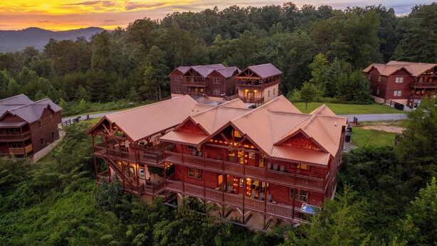 A large log cabin with multiple balconies and a central courtyard. - Private Indoor Heated Pool, Arcade, HotTub Sleeps24 (Sevierville)