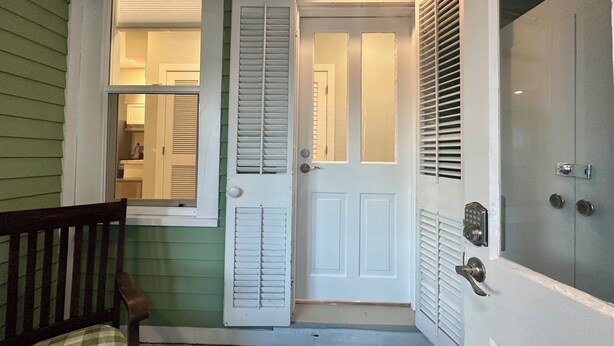 A front door with a mailbox, a bench, and a doormat. - Cozy Cottage Retreat • 5 Min to Cedar Point • Deck + Screened Patio (Sandusky)