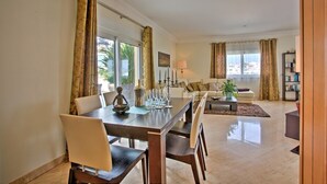 A spacious living room with a dining area, large windows, and a view of the city. - Excellent Private Penthouse with lots of space (Lagos)