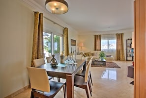 A spacious living room with a dining area, large windows, and a view of the city. - Excellent Private Penthouse with lots of space (Lagos)