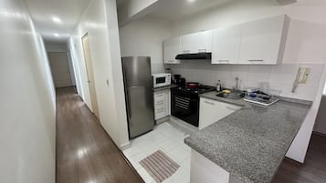 Coffee/tea maker, fridge, oven, cookware/dishes/utensils