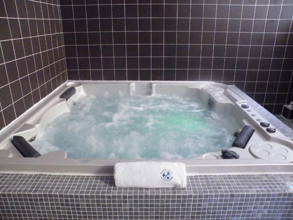 A hot tub with a control panel and a towel.