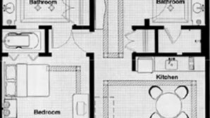 Een plattegrond met een slaapkamer, twee badkamers, een keuken en een woonkamer.