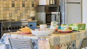 A kitchen with a tiled backsplash, a stove, a microwave, and a refrigerator. - CASA PATRON-Large Italian Alps Holiday Home Italy- 1h from Turin- Pet friendly (Pecco)
