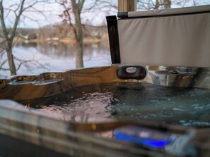A hot tub with a control panel and a view of a lake. - Blue Blessing, Hot tub, Waterfront, bunk room (Goreville)