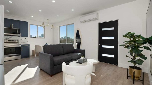 A modern apartment with a kitchen, living area, and a large window. - Refined Retreat in Banker's Hill (San Diego)