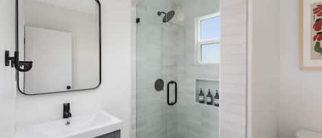 Shower, hair dryer, towels, shampoo