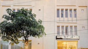 A hotel building with a sign reading "HOTEL EAST GATE BY VABLIH HOSPITALITY". - Hotel East Gate By Vablis Hospitality (Agra)