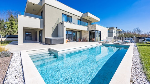 A modern two-story house with a swimming pool, outdoor seating, and a well-maintained garden. - Designer Beach Villa Limes - Pool, Spa & Games (Funtana)