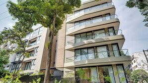 A multi-story building with balconies, large windows, and a modern architectural design. - Deluxe 2-bed  Walk to Cali's Best Dining 103 (Cali)