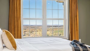 A bed with a view of a landscape through a window. - Luxury Mountain Retreat w/ Valley Views, Hot Tub (Front Royal)