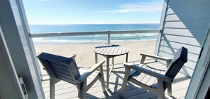 A balcony with a view of the beach and ocean. - Condo #108 with beautiful sunset view from your balcony overlooking the ocean (Lincoln City)