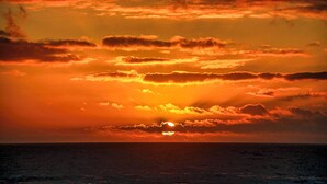 A sunset over the ocean with a clear sky and clouds. - Condo #206 with beautiful sunset view from your balcony overlooking the ocean (Lincoln City)