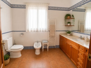 A bathroom with a toilet, bidet, wooden vanity, and a towel rack. - Historic Villa with Private Pool & Gardens near Valencia (Alzira)
