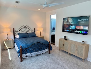 A bedroom with a bed, nightstands, a TV, and a cabinet. - EaDO Stadium Loft w/ Rooftop and Walkable to Games & Metro for FIFA (Houston)