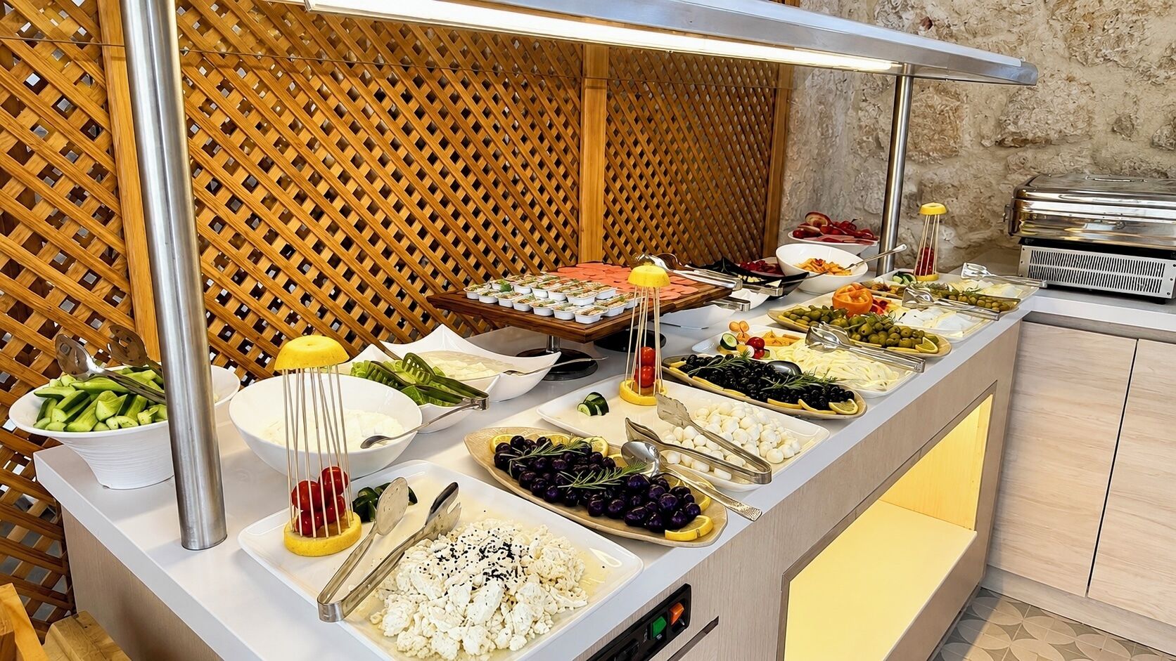 A buffet with various food items and a grill station.