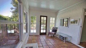 A sunlit room with large windows, a door, and a bench. - 3B Near Englewood Beach! Pet Friendly Sunlit Home (Englewood)