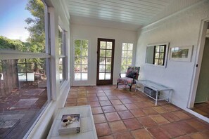 A sunlit room with large windows, a door, and a bench. - 3B Near Englewood Beach! Pet Friendly Sunlit Home (Englewood)