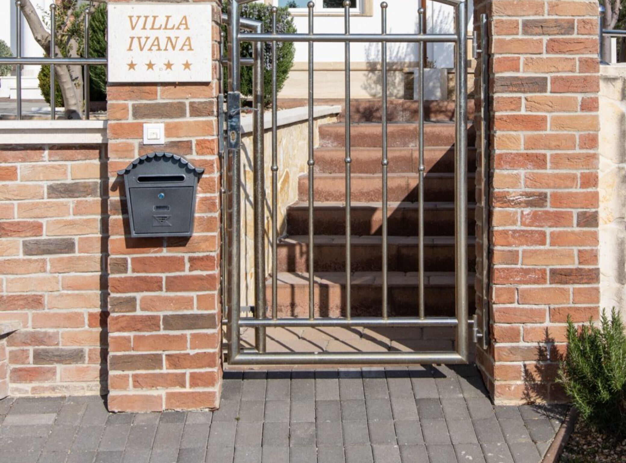 A gated entrance with a mailbox and a sign reading "VILLA IVANA".