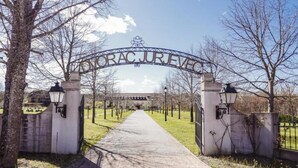 A paved pathway leading to a building entrance with a sign reading "ORAC JUAREZ". - Jurjevec Castle - Standard room 2 (Brezane Lekenicke)