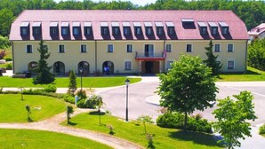 A large, two-story building with a symmetrical facade, multiple windows, and a central entrance. - Jurjevec Castle - Standard room 7 (Brezane Lekenicke)