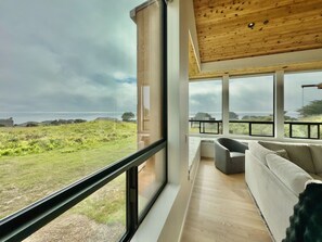 TV, fireplace, books - Sea Legacy | New Construction, Ocean View, Hot Tub (Sea Ranch)