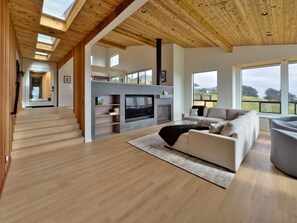 TV, fireplace, books - Sea Legacy | New Construction, Ocean View, Hot Tub (Sea Ranch)