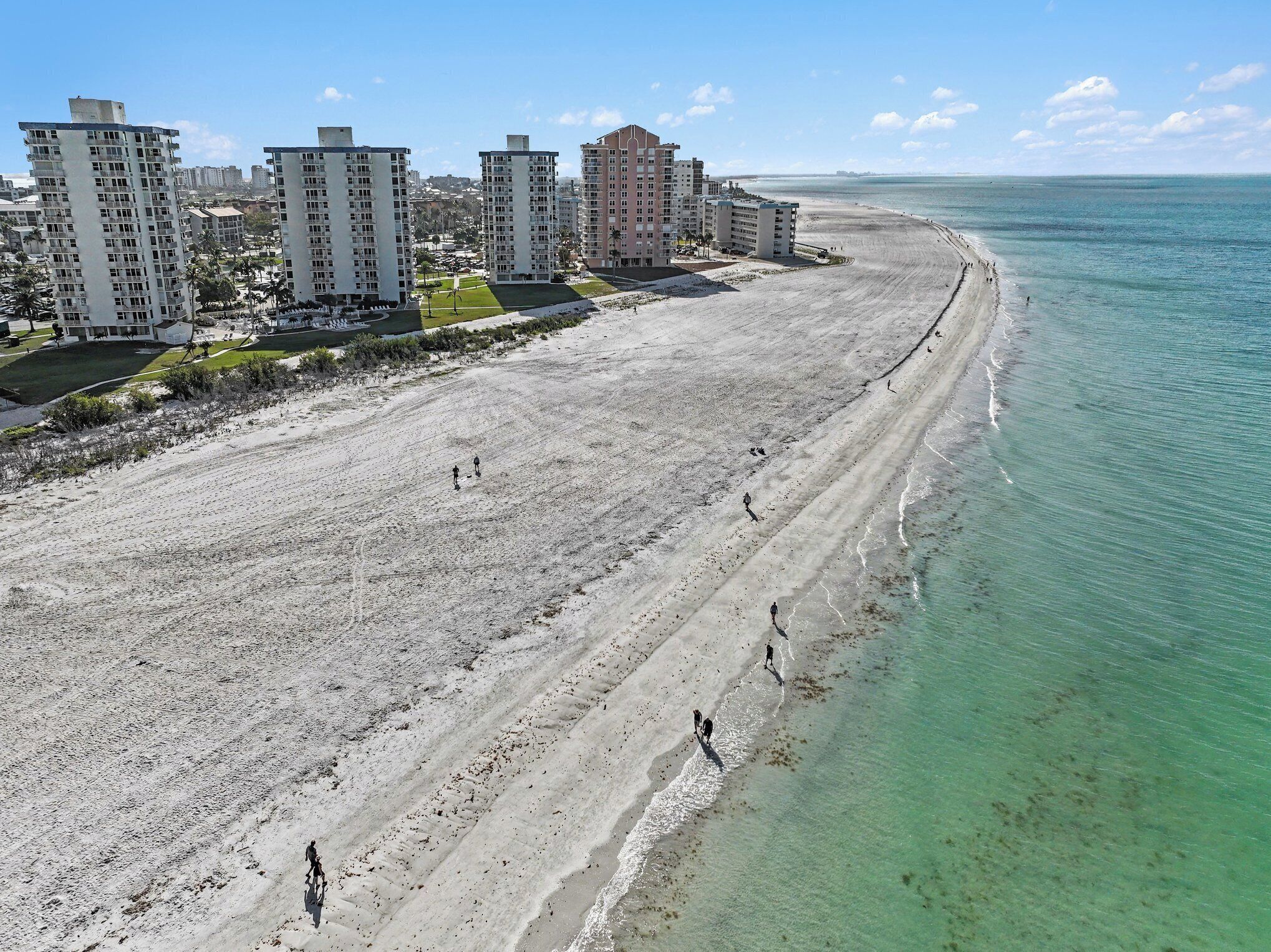A beach with high-rise buildings in the background.