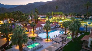 A resort with a large pool, palm trees, and mountain views. - La Quinta 2BR| Mountain & Golf Views + Resort Pool (La Quinta)