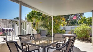 A covered patio with a glass table and chairs, surrounded by plants and an American flag. - Pool & Patio! Gem 4 Mi to Fort Lauderdale Beach (Fort Lauderdale)