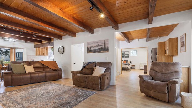 A spacious living room with a brown leather sofa, a recliner, and a patterned rug. - The Herold's Shaver Lake Retreat | BBQ, Fire pit+ (Shaver Lake)