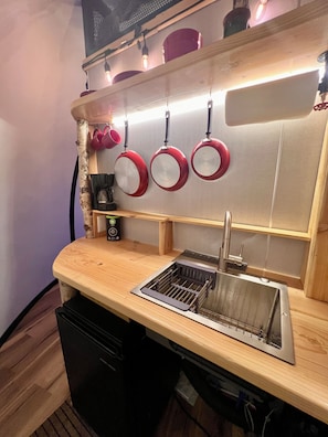 A kitchen with a wooden countertop, a stainless steel sink, and red hanging pots. - Aurora Igloo w/ Hot Tub & Firepit near town. (Fairbanks)