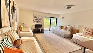 A spacious living room with two sofas, a coffee table, and a television. - Vila Algarvve II-5 mn walking from Beach-heated pool-see view-16 pax (Albufeira)