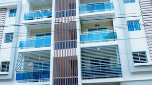 A multi-story building with balconies, a sign indicating 'Residencial Balcones del Yacaz II', and a gated entrance. - Fabulous apartment in the center of jarabacoa rep dom. (Jarabacoa)