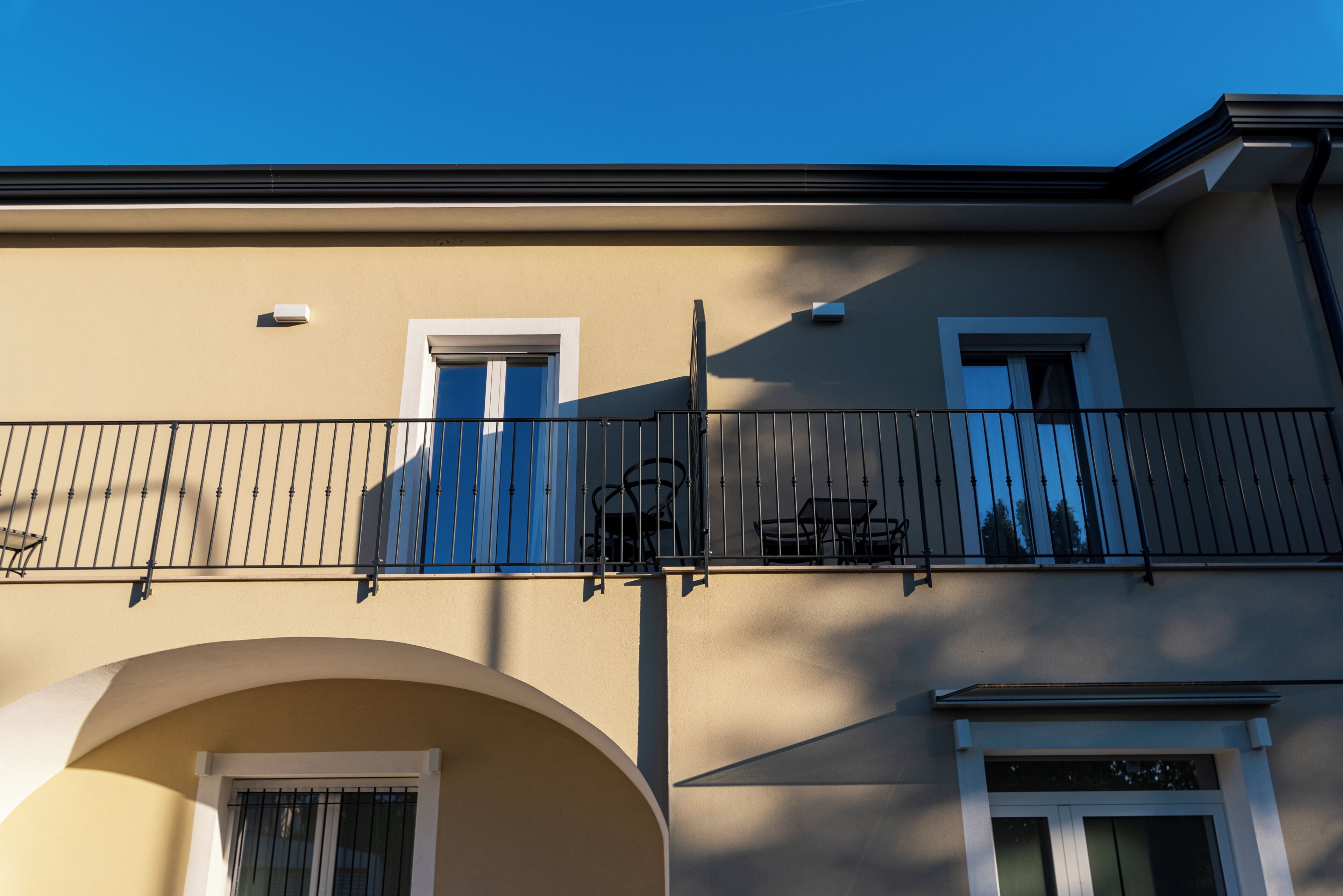 A building with a balcony, a door, and a window.