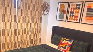 A bedroom with a bed, a headboard, a pillow, a wall-mounted artwork, and a curtain. - Room-room in Blackburn - Peters Place (Blackburn)