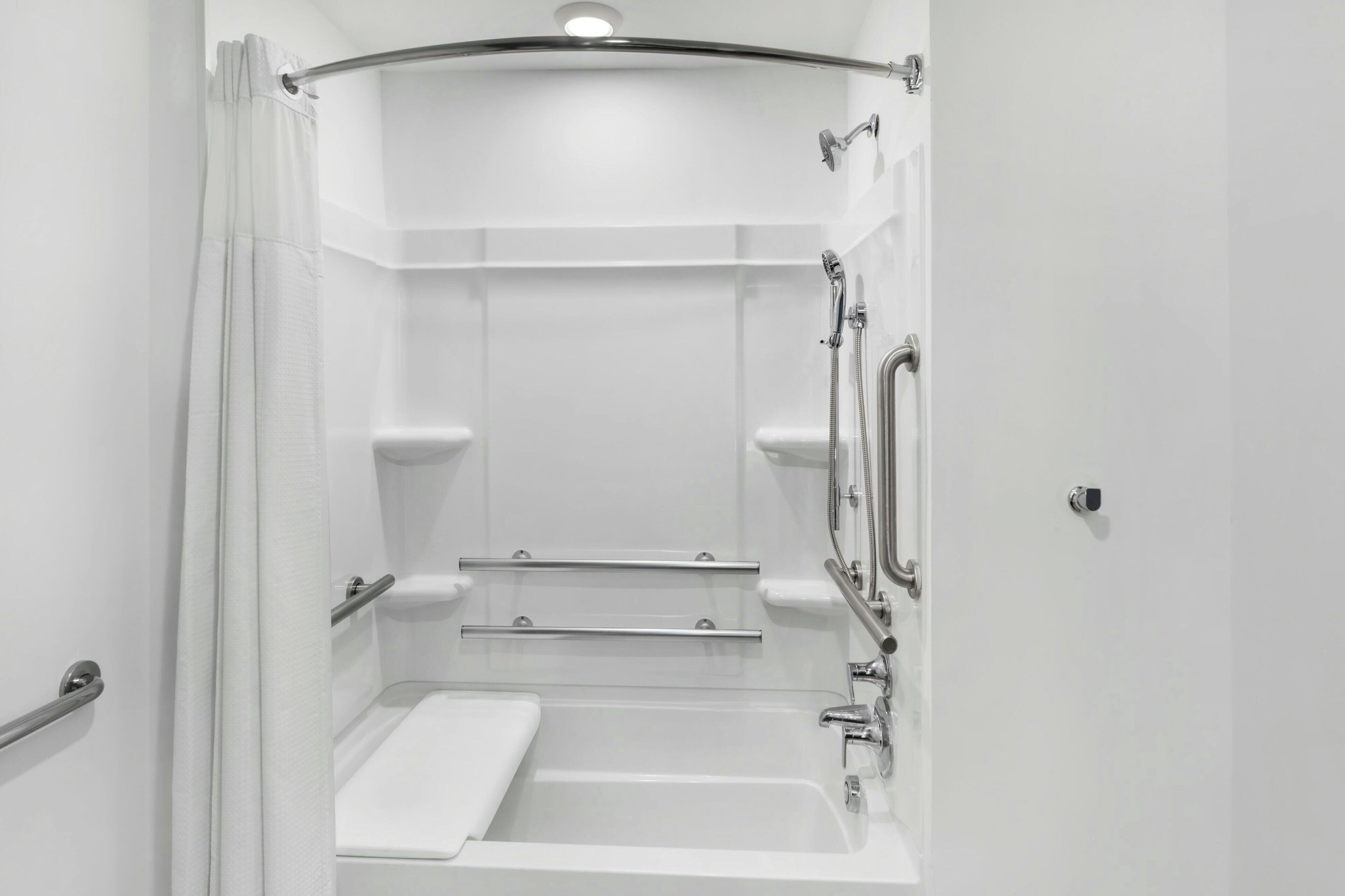 A modern bathroom with a shower, a toilet, and a sink.