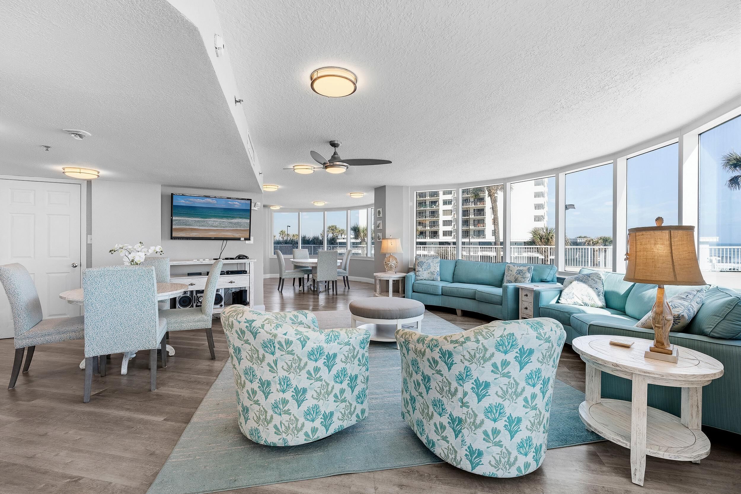 A spacious living area with a dining set, a sofa, and a coffee table.