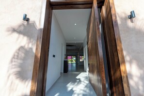 A hallway with wooden beams, a ceiling light, and a door leading to another room. - Villa Adam Luxe Marrakech, 5 Suites, Large Private Pool, sleeps 11 (Marrakech)