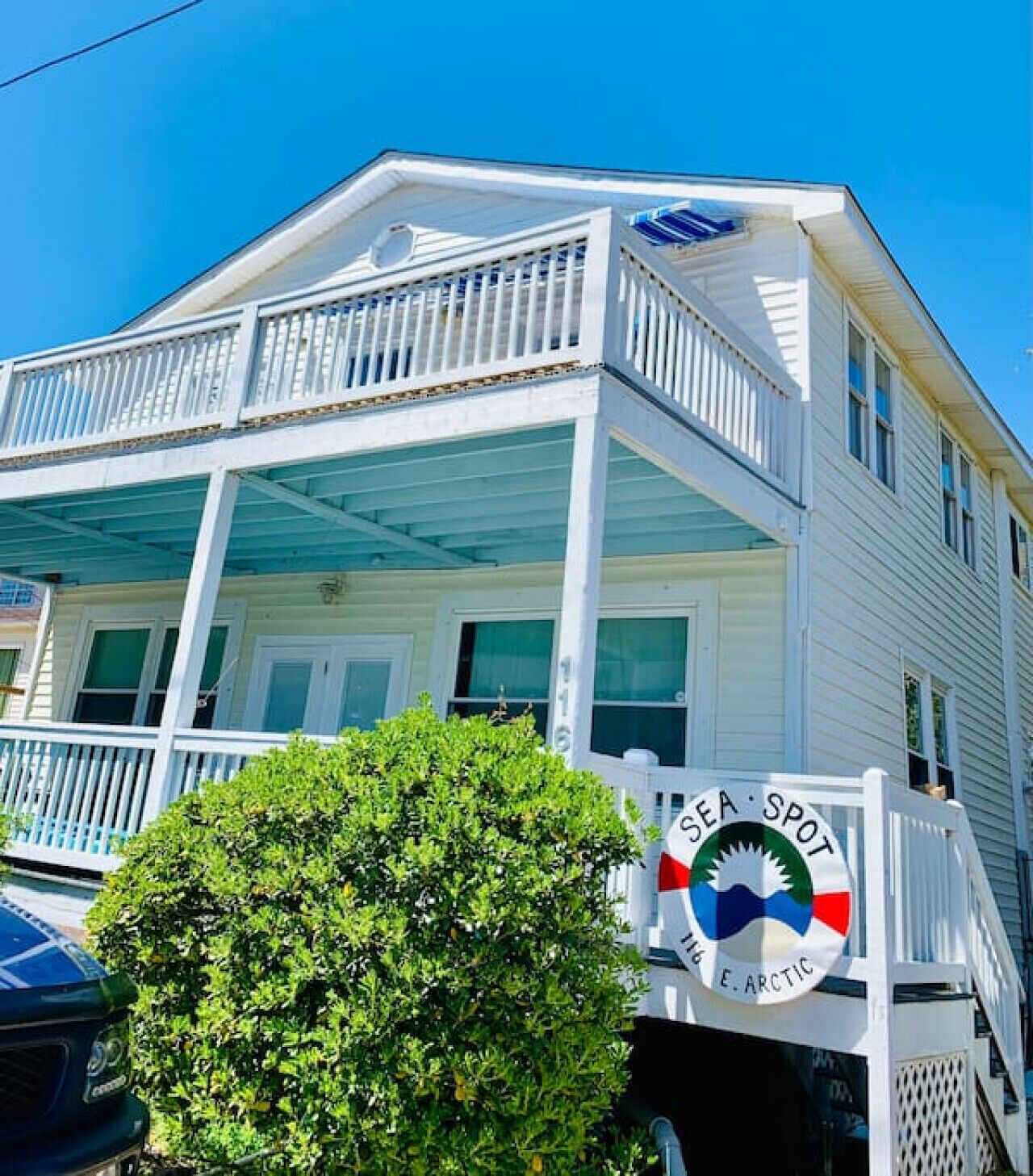 A two-story building with a balcony and a sign that reads "SEA SPOT E. ARCTIC".