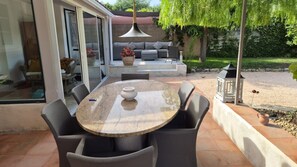 An outdoor patio with a round table, chairs, and a sofa. - Villa NAHEMA – Private Pool, 2 Minutes from Port Grimaud Gulf of Saint-Tropez (Grimaud)