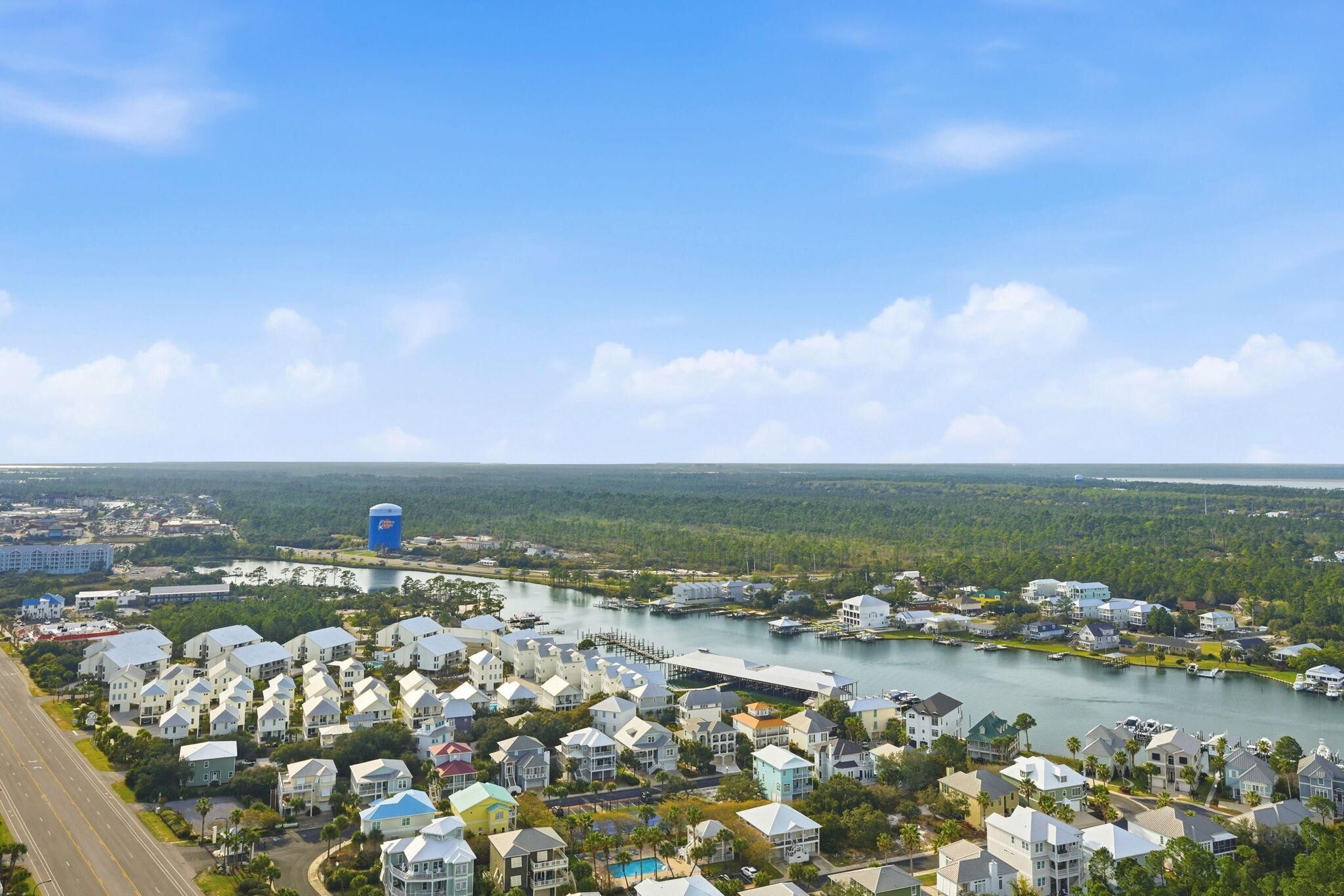 A coastal residential area with houses, a marina, and a large water body.