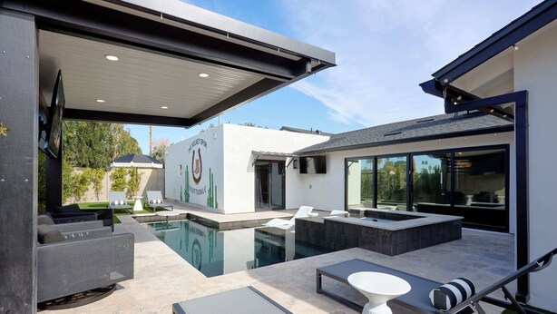 A modern outdoor pool area with lounge chairs, a hot tub, and a well-maintained lawn. - Velvet Spur | Designer Stay in Old Town! Walkable (Scottsdale)