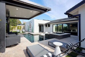 A modern outdoor pool area with lounge chairs, a hot tub, and a well-maintained lawn. - Velvet Spur | Designer Stay in Old Town! Walkable (Scottsdale)