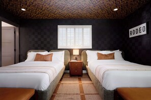 A hotel room with two beds, a wooden ceiling, a window with blinds, a nightstand, and a wall sign. - Velvet Spur | Designer Stay in Old Town! Walkable (Scottsdale)