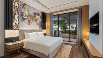 A modern hotel room with a large bed, a nightstand, a digital clock, a wall-mounted TV, and a large window with a view of greenery.