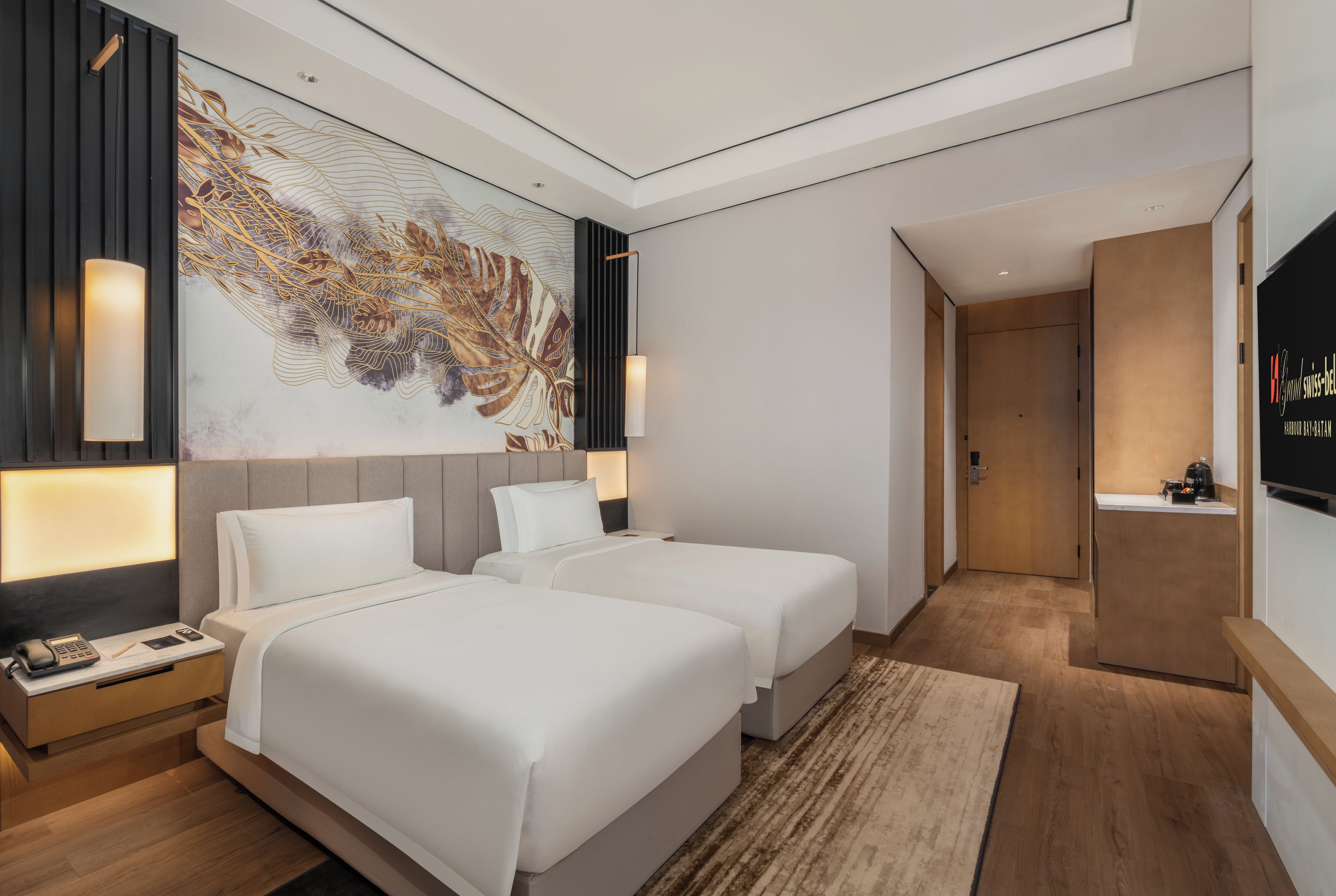A hotel room with two beds, a large abstract wall art, a flat-screen TV, and a wooden cabinet.