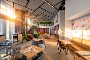 A modern restaurant with a staircase, multiple dining areas, and a large window with natural light. - Miami Bay Million-Dollar View - Private Condo - Pool - Gym - Sleeps 4 (Miami)
